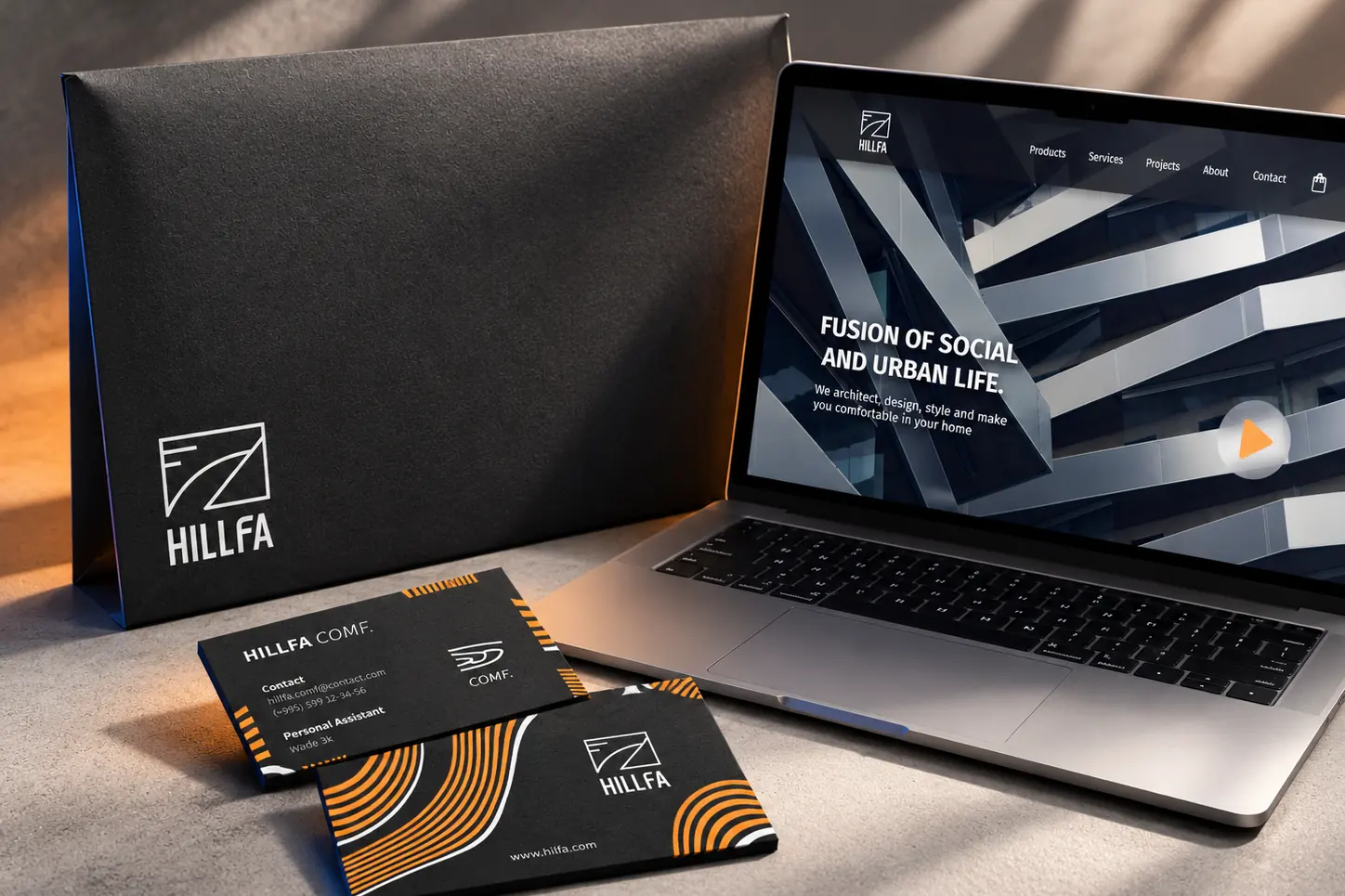 HILLFA project folder, COMF business cards and the website on a laptop