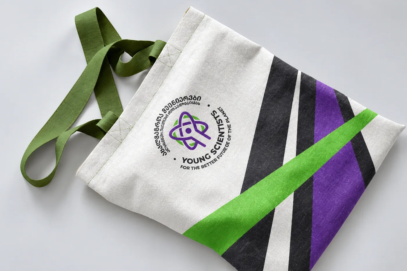Young Scientists tote bag with the logo and diagonal purple and green stripes